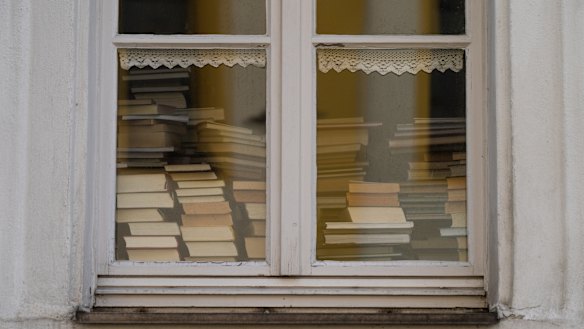 Books piled up in the window of a library in Bavaria. COVID-19 has led to library closures around the world. 