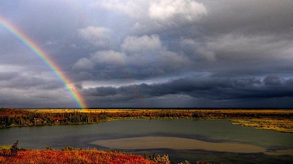 A rainbow shines over Esieh Lake, with the seep field of methane gas visible in the centre. 