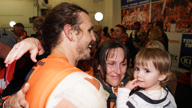 'Warrior': Phil Davis enjoys the victory with his family at the MCG.