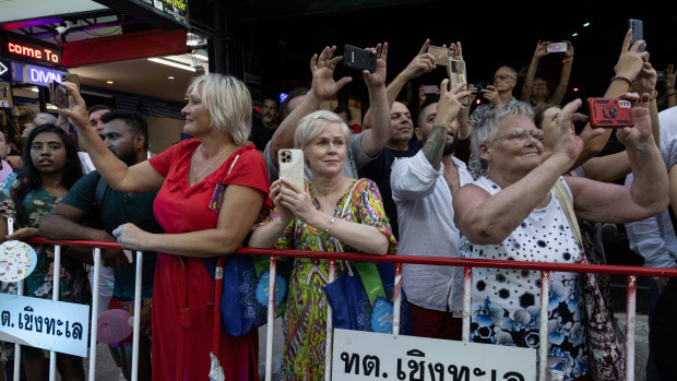 A group of Russians watch an annual parade along Patong beach last December.