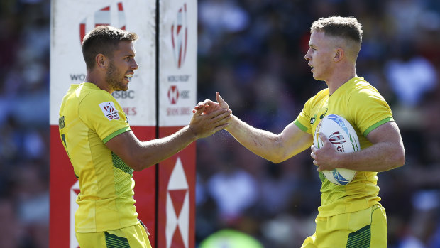 Henry Hutchison celebrates with Josh Turner after scoring a try during Australia's semi-final against New Zealand in Hamilton.  