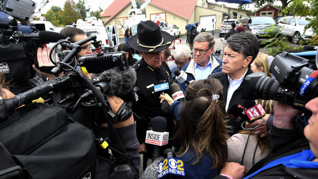 Schoharie County sheriff Ronald Stevens (left) and New York State senator James Seward (centre) speak to reporters at the scene of the crash.