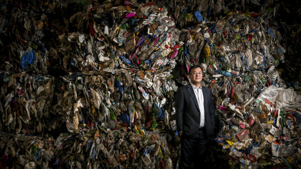 Harry Wang with a wall of plastics ready for recycling at his Advanced Circular Polymers plant in Somerton.
