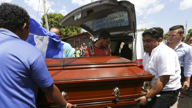 Men carry the casket of Alvaro Manuel Conrado Davila, a 15-year-old student who died during the protests on Friday.