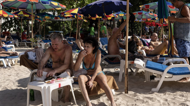 Russian tourists enjoy the warm weather at Patong beach, Phuket.
