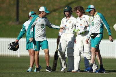 Will Pucovski is assisted from the field on Tuesday.