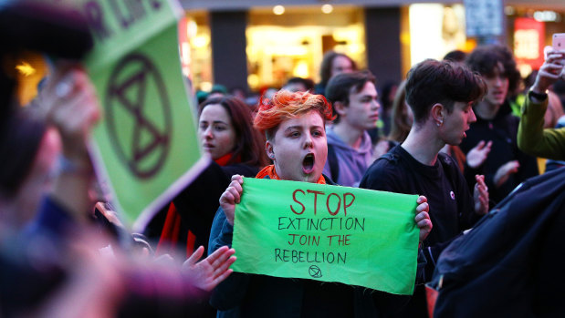 Protesters stop traffic on Swanston Street as they raise awareness for climate change.