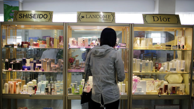 A woman looks at a display of imported cosmetics and perfume on the second level of the upscale Potonggang department store in Pyongyang, North Korea.