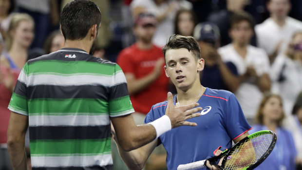 Ceasefire: Marin Cilic and Alex de Minaur at the net after going toe to toe in the early hours of the New York morning.