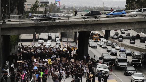 Demonstrators walk along the 110 Freeway during a protest in Los Angeles over the death of George Floyd.