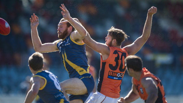 Canberra's Cameron Milne and Giants' Matthew Flynn clash at Manuka Oval on Saturday.