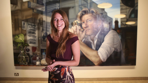 Tessa MacKay poses with her Packing Room prize portrait of David Wenham.