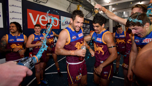 Charlie Cameron and Luke Hodge at the centre of Lion celebrations after the win over Hawthorn.