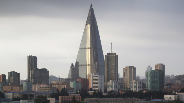 The unfinished, unopened 105-story pyramid-shaped Ryugyong Hotel towers over residential apartments.