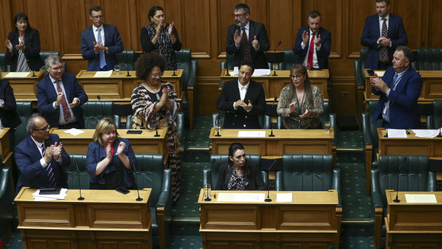 Prime Minister Jacinda Ardern is applauded by colleagues after her speech.