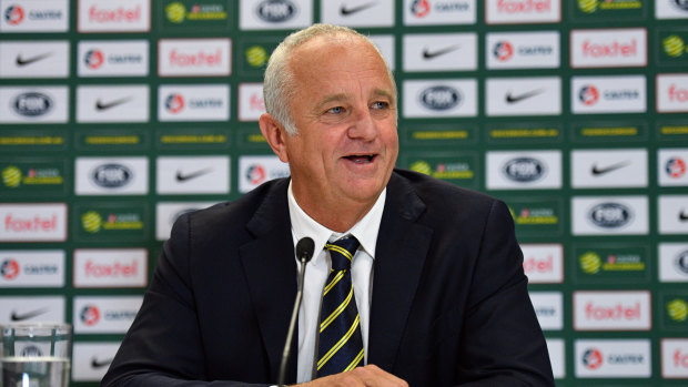 Dual roles: Australian coach Graham Arnold speaks to the media during a press conference in Sydney.