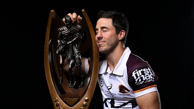 Ben Hunt gets up close and personal with the NRL trophy.