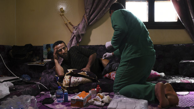 Shiyar Noushtiman has his wound dressed at a house in Hassaka where SDF soldiers are recuperating from their injuries.