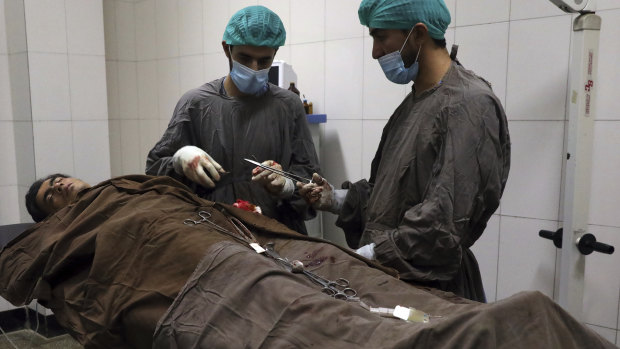 A man is treated at a hospital after a deadly attack at Kabul University, in Kabul, Afghanistan, on Monday.