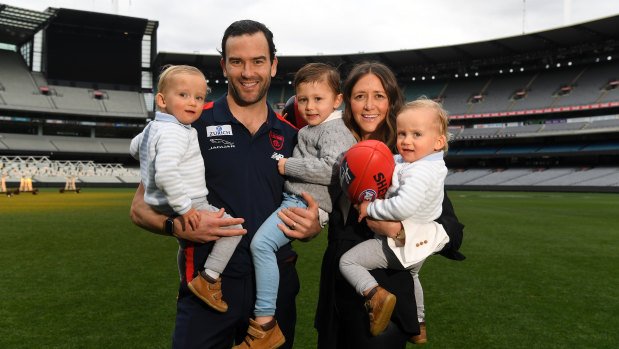 Jordan Lewis and wife Lucy pose with their kids Hugh, Freddie and Ollie at the MCG.