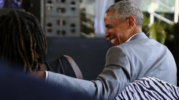 Former US President Barack Obama speaks with his half sister Auma Obama, in Kogelo, Kenya.