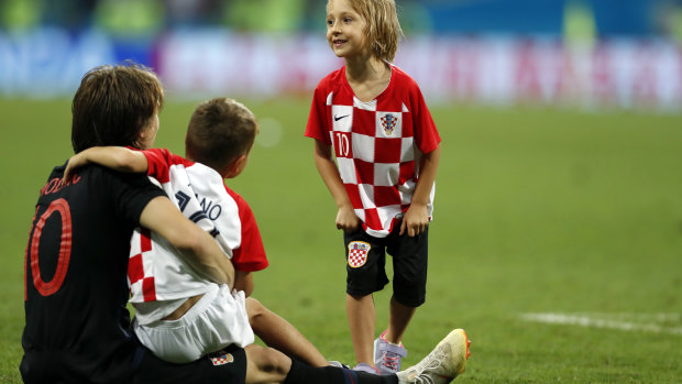 Croatia's Luka Modric, left, celebrates with children. 