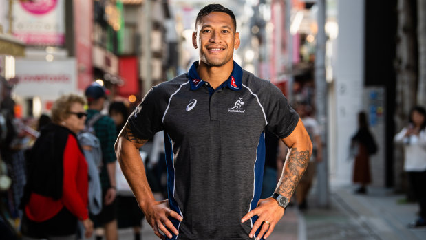Star attraction: Folau poses for the cameras at a Wallabies fan event at the Asics store in Tokyo.