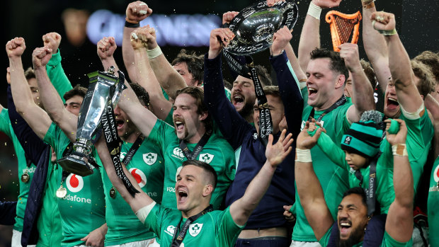 Johnny Sexton, Ireland captain, holds the Six Nations trophy as Ireland celebrate their Grand Slam victory.