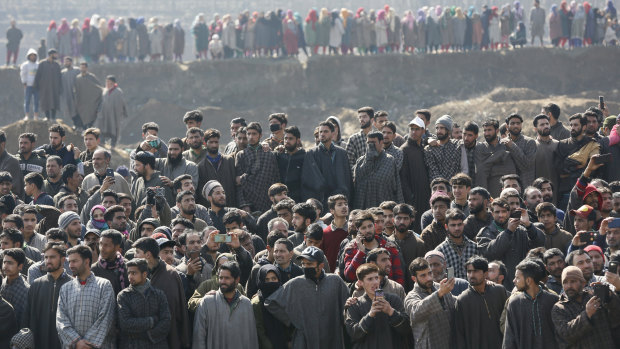 Kashmiri villagers gather to look at the wreckage of an Indian aircraft after it crashed in Budgam area on Wednesday.