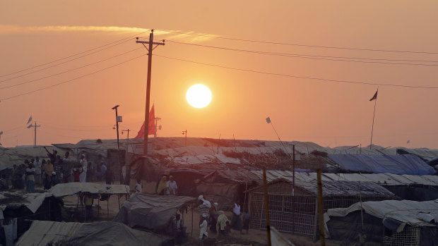 Rohingya Muslim refugees make their way between tents as the sun sets in Kutupalong refugee camp in Bangladesh.