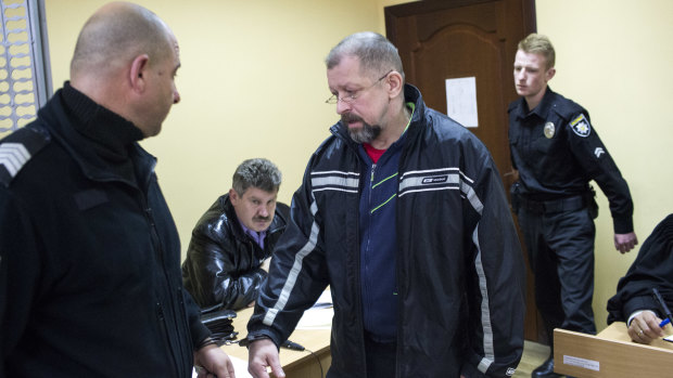 Oleg Smorodinov arrives for his trial in a courtroom in Rivne accused of the murder of Ivan Mamchur.