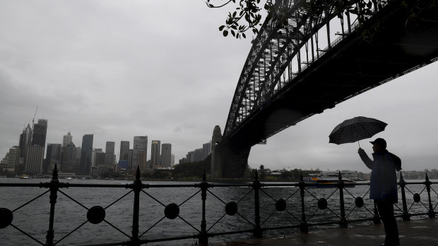 A tourist is seen as rain continues to fall in Sydney.