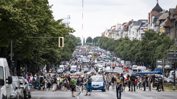 Demonstrators walk along Bismarckstrasse in Berlin.