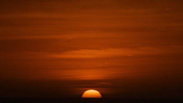 A view of the sun rise from Newport beach in Sydney's north on December 28, 2018 - the warmest night on record for Australia for that month.