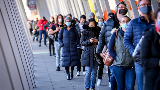 People queue up for COVID-19 vaccination at the Melbourne Convention and Exhibition Centre early on Wednesday morning.