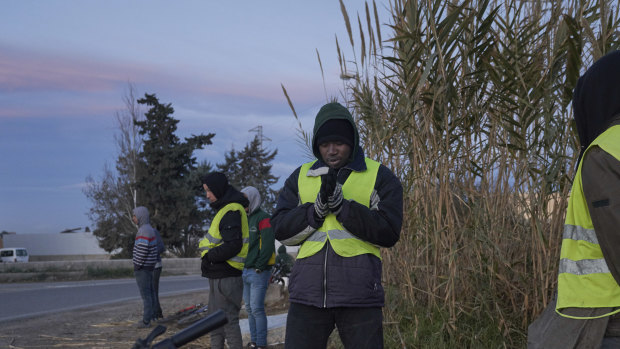Migrants seeking day labour on farms gather in El Ejido, Spain, on January 23.