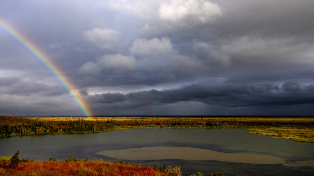 A rainbow shines over Esieh Lake, with the seep field of methane gas visible in the centre. 