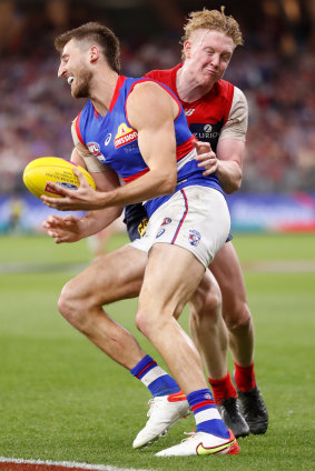 Clayton Oliver tackles Marcus Bontempelli.