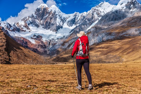 Memories are made of this: A hiker surveys a snowy peak while trekking in the Peruvian Andes.