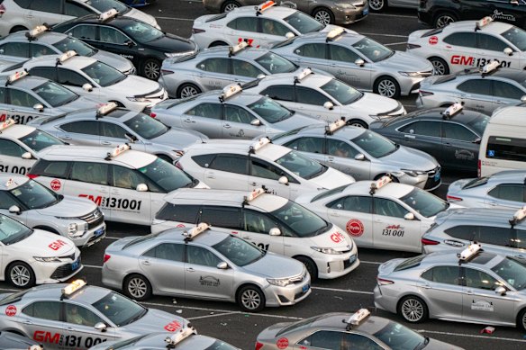 Taxis wait to join the cab ranks outside Sydney’s busy domestic airport terminals.