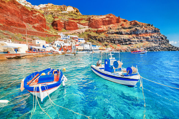 The clear waters of the old port at Oia, Santorini, Greece.