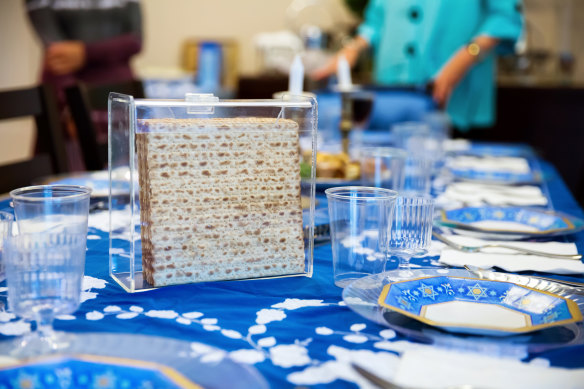 A family gathers around a seder table during Passover.