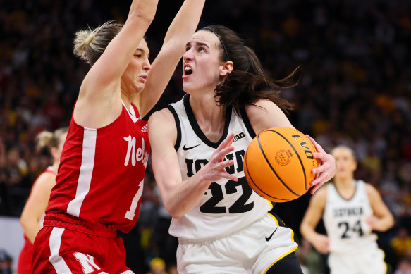 Nebraska’s Jaz Shelley (left) defends a drive from Iowa’s Caitlin Clark (right).