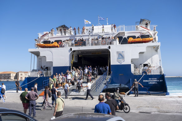 A ferry disgorging its passengers.