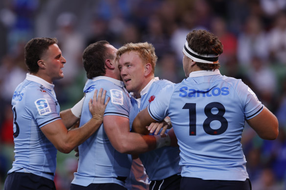 The Waratahs celebrate against the Crusaders