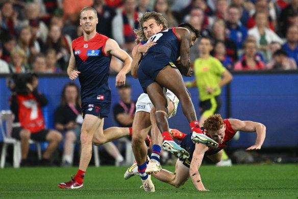 Melbourne’s Kysaiah Pickett ploughs into Bailey Smith on Saturday night at the MCG.