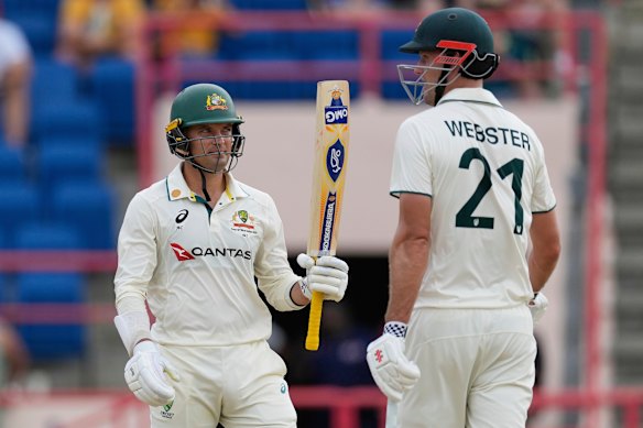 Alex Carey celebrates with partner Beau Webster after scoring a half-century against the West Indies during day one of the second Test. 