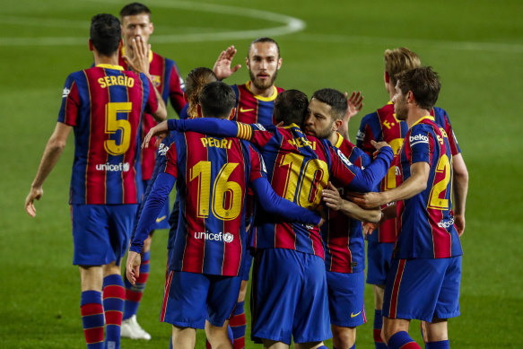 Lionel Messi is congratulated by Barcelona teammates after scoring against Getafe on Thursday (Friday AEST).