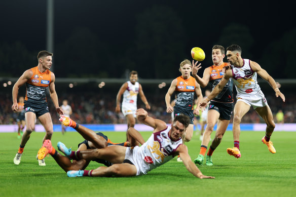 The Giants’ Josh Kelly competes with Lions forward Charlie Cameron for the ball in their Anzac Day clash.