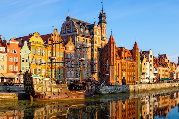 The historic riverside promenade in Gdansk is a popular gathering spot for visitors and locals alike.